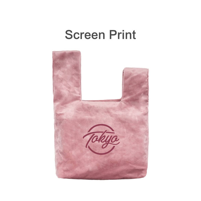 A pink velvet wrist bag featuring a logo on the front with a soft texture and a unique handle design.