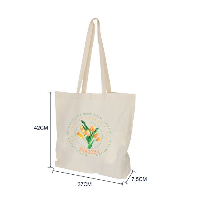 A cream calico bag with long handles and a gusset, featuring a floral logo design.