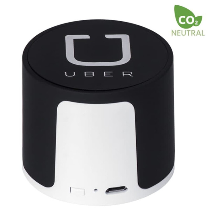 A black and white wireless speaker featuring a logo and a USB port. The design is cylindrical and compact. A black and white wireless speaker featuring a logo and a USB port. The design is cylindrical and compact.