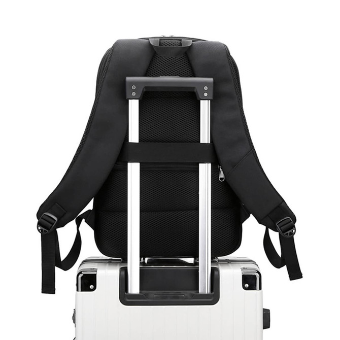 A black expandable laptop backpack resting on a wheeled suitcase, showcasing padded straps and back panel.