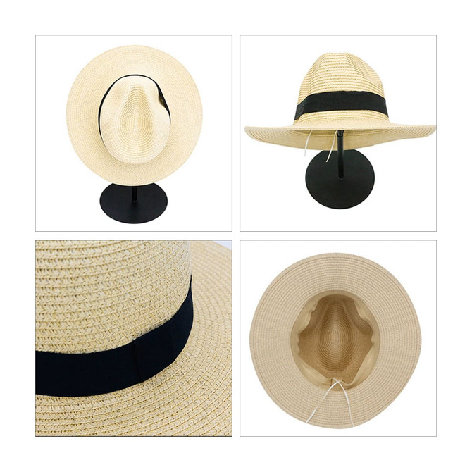 A Panama beach sun hat in light beige with a black band, displayed from multiple angles on a stand.