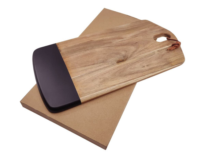 A wooden cheese board with a black edge, resting on a brown cardboard base. Features a handle for easy carrying.