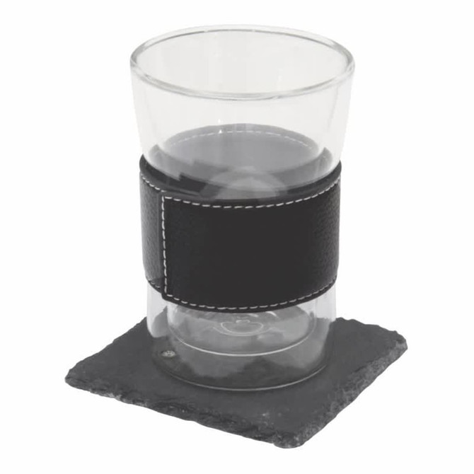 A black leather-wrapped glass sits on a square slate coaster. The set includes a coaster and a drink glass.