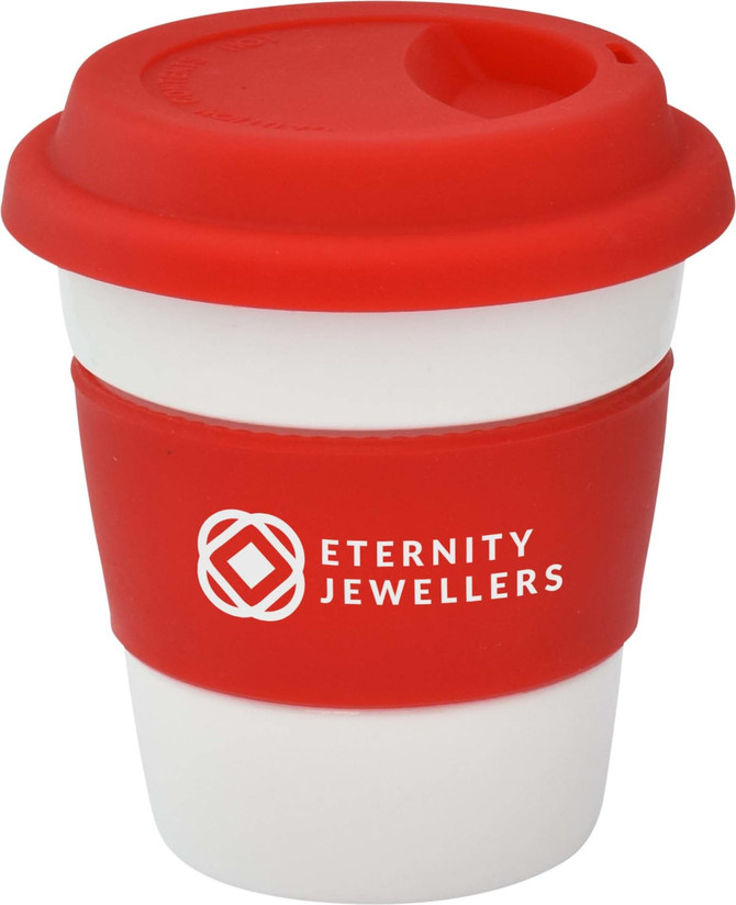 A reusable ceramic coffee mug with a red silicone lid and grip, featuring a logo on the front.