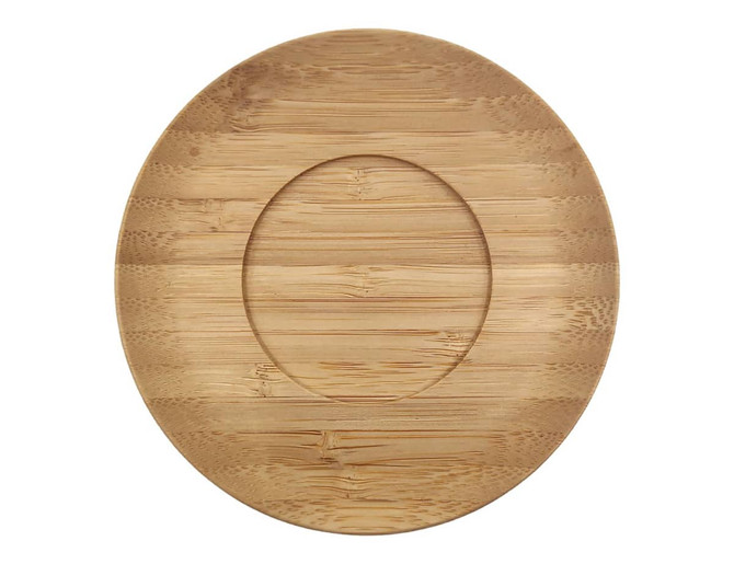 A bamboo saucer with a smooth, natural finish and an oval shape, featuring a recessed area for a mug.