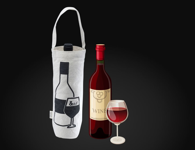 A calico wine bag in natural colour, featuring a logo, alongside a wine bottle and a glass of red wine.