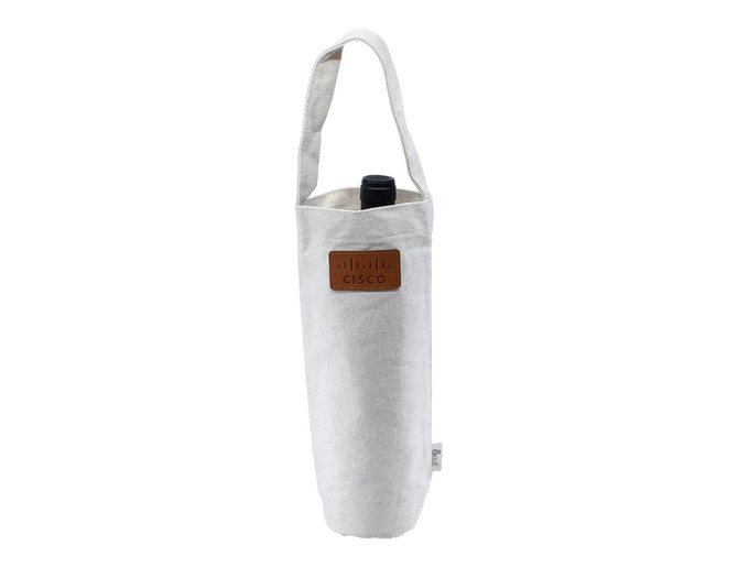 A calico wine bag in off-white, featuring a long handle and a logo, designed to hold a standard wine bottle.