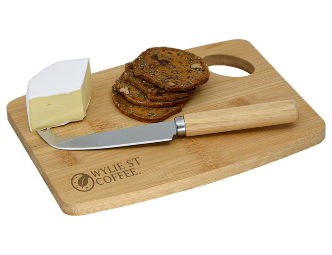 A bamboo cheese board with knife, featuring a wedge of cheese and a stack of crackers. The knife has a wooden handle.