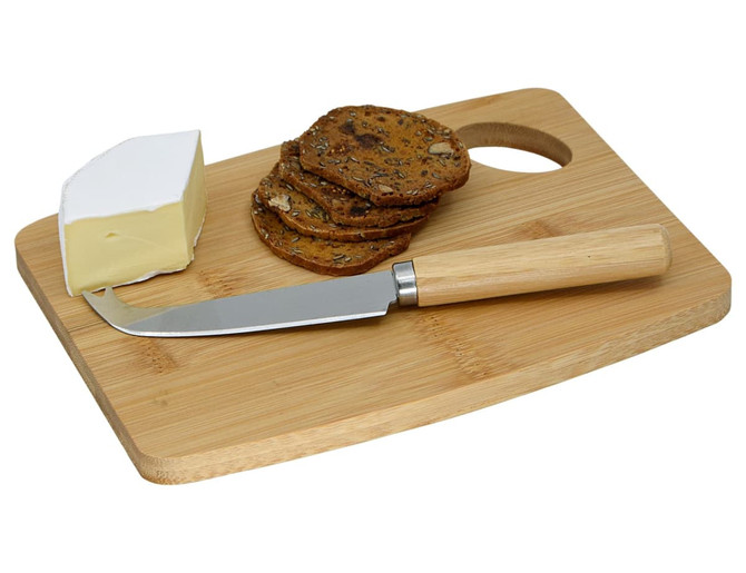 A bamboo cheese board featuring a cheese wedge, crispbread, and a cheese knife with a wooden handle.