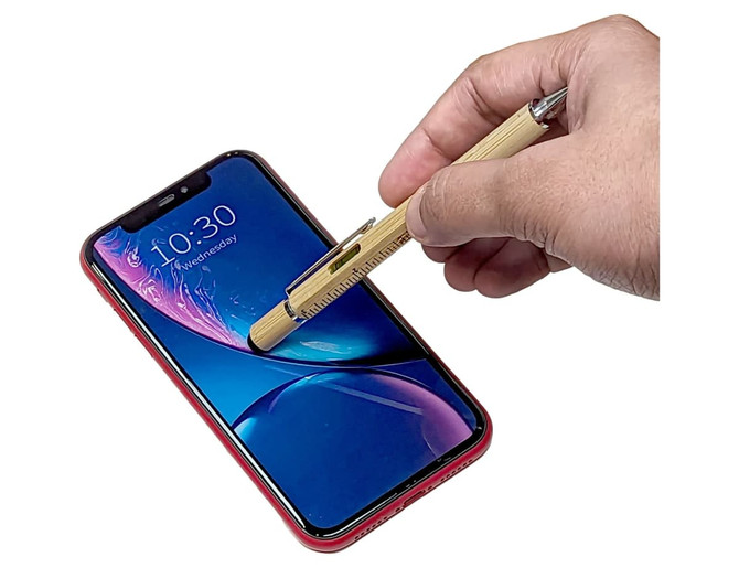 A bamboo stylus pen is held above a smartphone screen, showcasing its natural wood finish and sleek design.