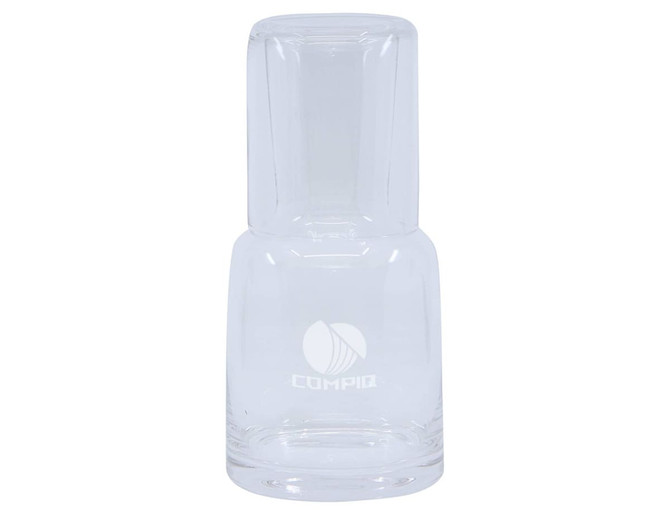 A clear glass carafe with a tumbler section, featuring a logo. Elegant and minimalist design.