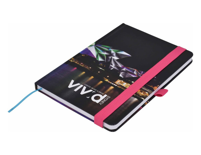 A5 notebook with a colourful geometric design on the cover, featuring a pink elastic band and blue ribbon marker.