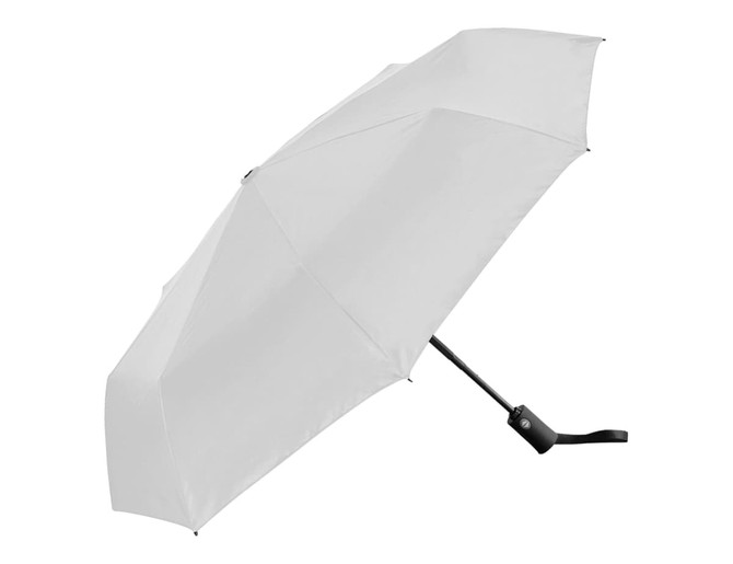 A folded white umbrella with a black handle and a logo on the shaft.