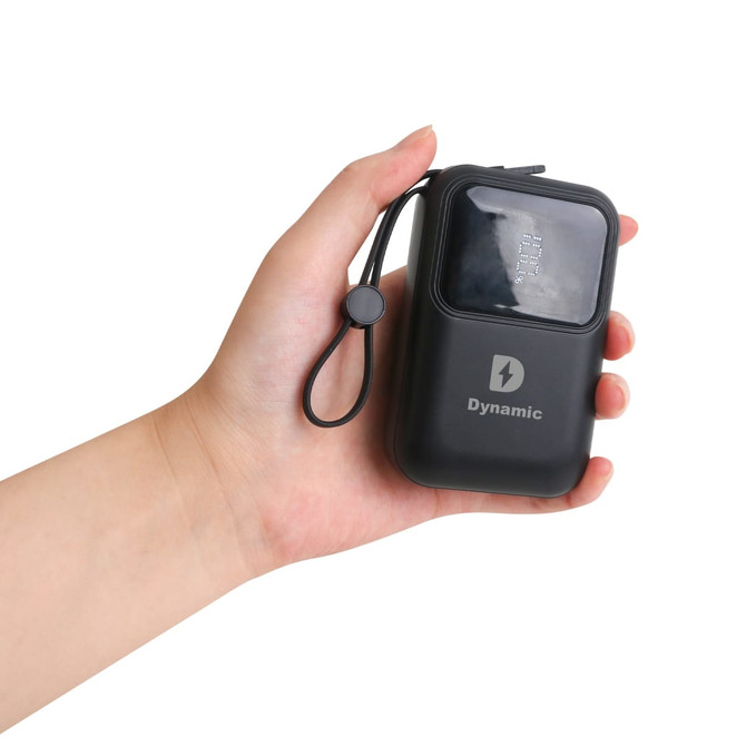 A black 10,000mAh eco portable fast charging power bank held in a hand, featuring a logo and a strap.