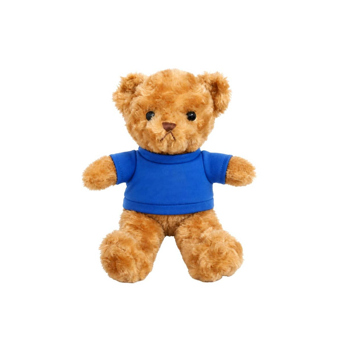 A plush teddy bear in soft golden-brown fur, wearing a blue t-shirt, with black button eyes and a stitched mouth.