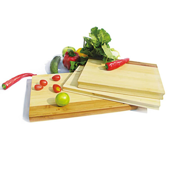 A set of bamboo chopping boards in various sizes, featuring fresh vegetables like tomatoes, chilli, cucumber, and lettuce.
