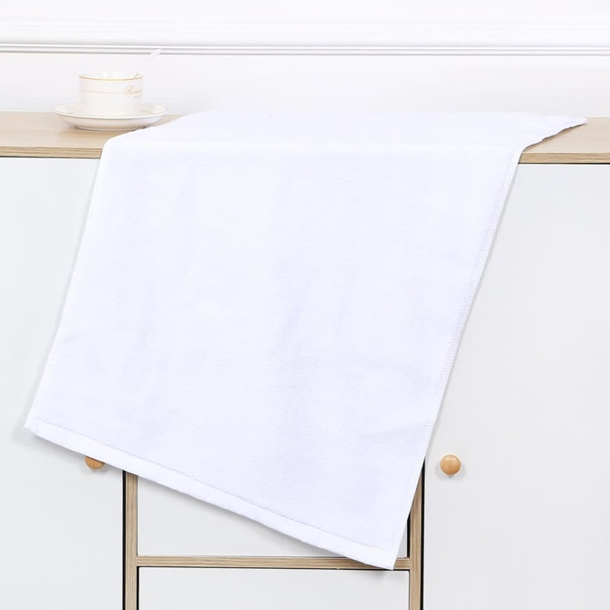A white gym towel draped over a wooden surface, featuring a simple design with a logo. A white gym towel draped over a wooden surface, featuring a simple design with a logo.