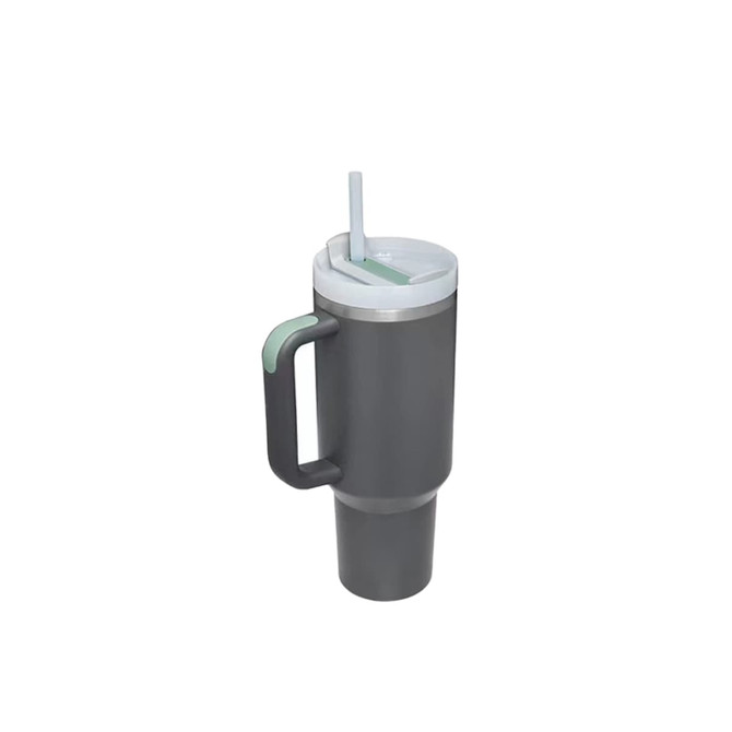 A drink bottle featuring a dark grey stainless steel body, a white lid, straw, and a green handle. Brand logo present.