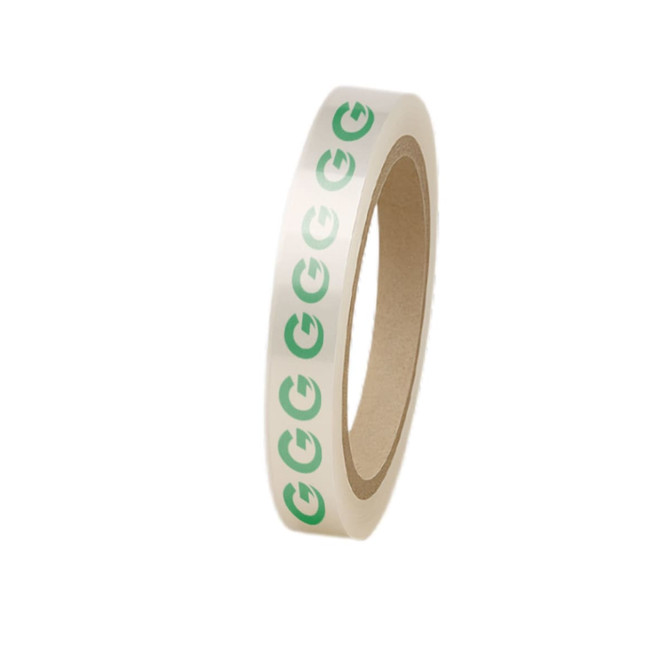 A roll of BOPP packing tape in clear material with green printed logos around the edge.