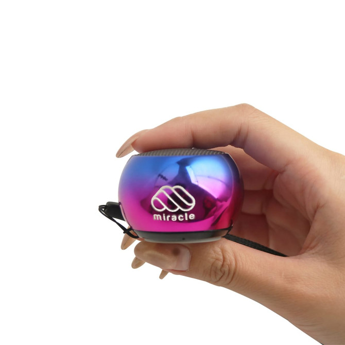 A Mini Bass Wireless Speaker in a vibrant purple and blue finish, held in a hand, featuring a logo.