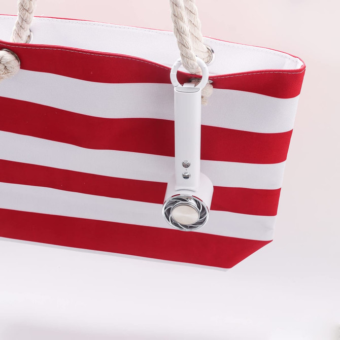 A red and white striped tote bag with a white personal cooling fan attached to it. The bag features rope handles.