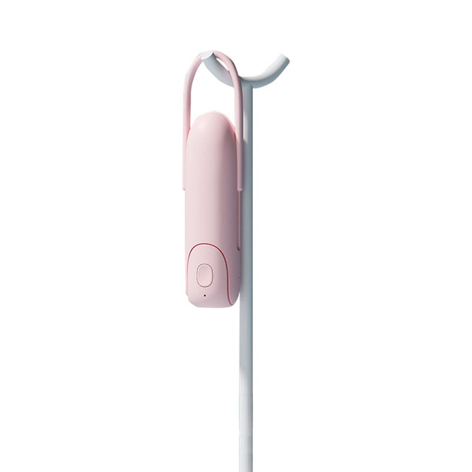 A pink USB handheld mini fan with a flashlight, designed with a hanging hook for easy storage.