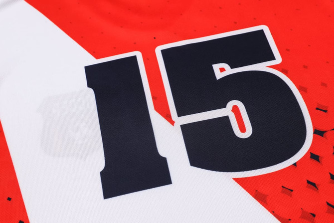 A red and white football jersey made of 100% polyester featuring the number 15 and a logo.