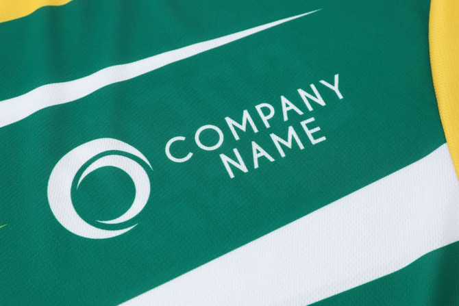 A green and yellow long-sleeved sports shirt featuring a logo and simple striped design.