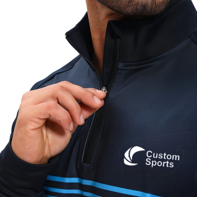 A dark navy quarter-zip raglan jacket with a high stand-up collar and a logo on the chest.