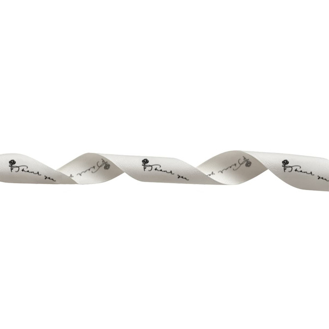 A spool of cream cotton ribbon with a printed black design running along its length. It has a branding logo.