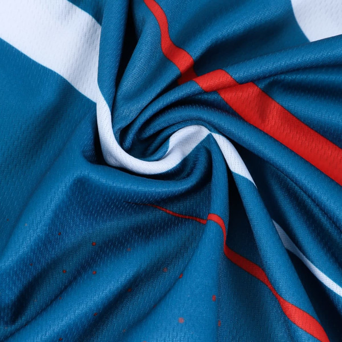 A close-up of blue fabric featuring red and white stripes, showcasing the texture of a polyester sports polo.