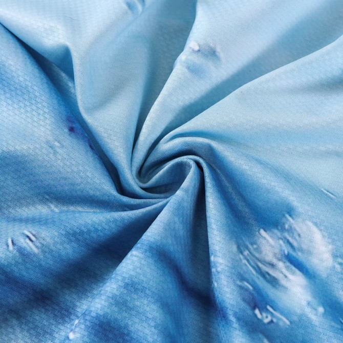 A close-up of light blue polyester spandex fabric with a textured pattern and a subtle sublimated design.