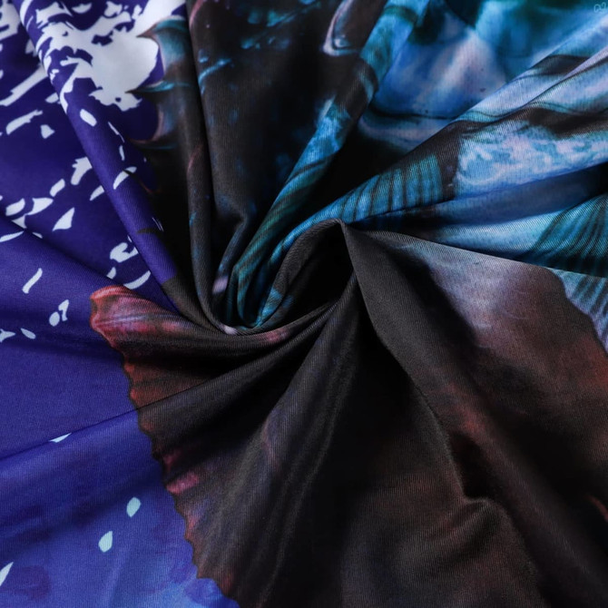 A close-up of a fabric featuring a vibrant, multicoloured pattern with shades of blue, purple, and black.