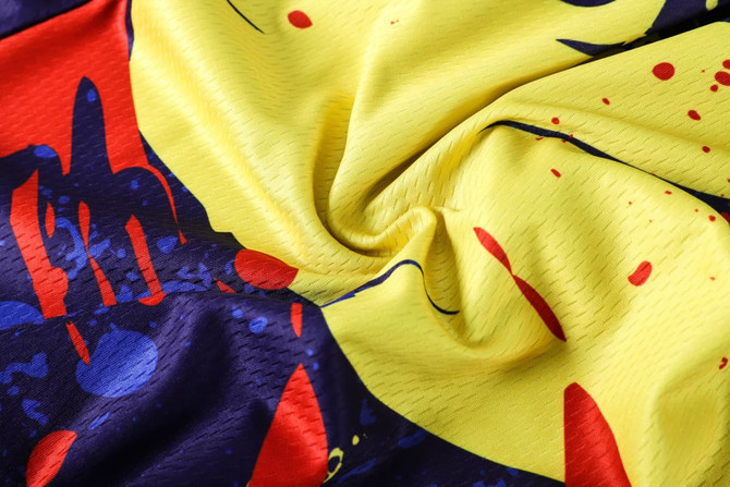 Men's long sleeve cycling jersey featuring a vibrant yellow, red, and blue design with a logo.