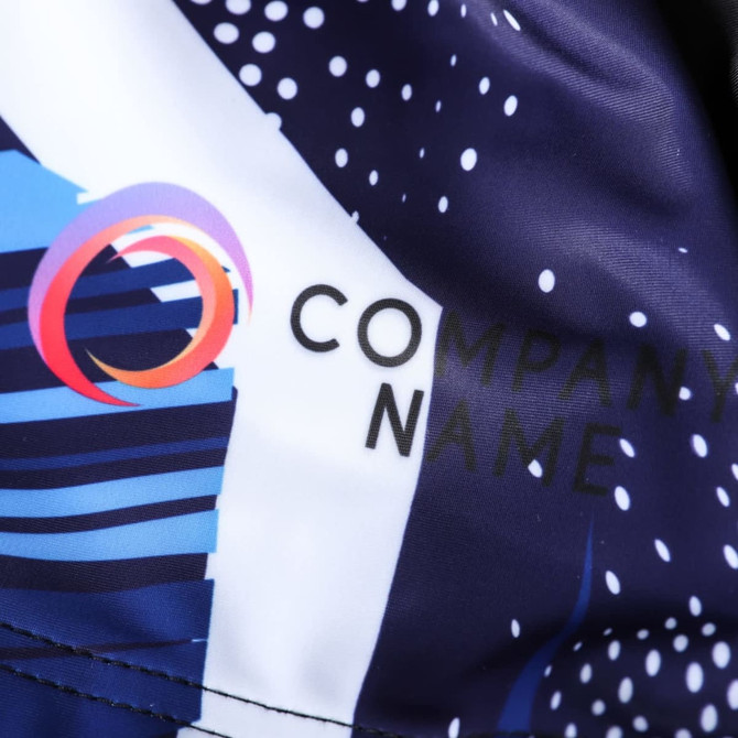A close-up of men's sublimated cycling bib shorts featuring a navy colour scheme and a company logo.