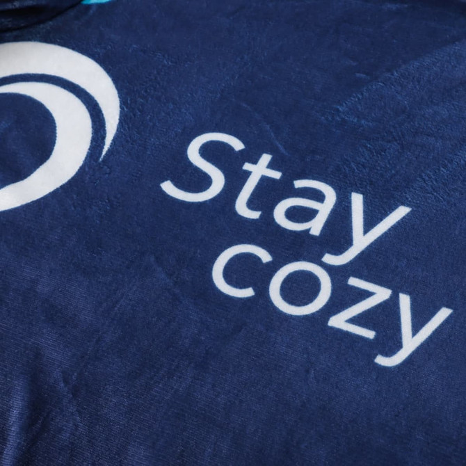A navy blue blanket featuring a smooth texture and a logo, with the words "Stay cozy" prominently displayed.
