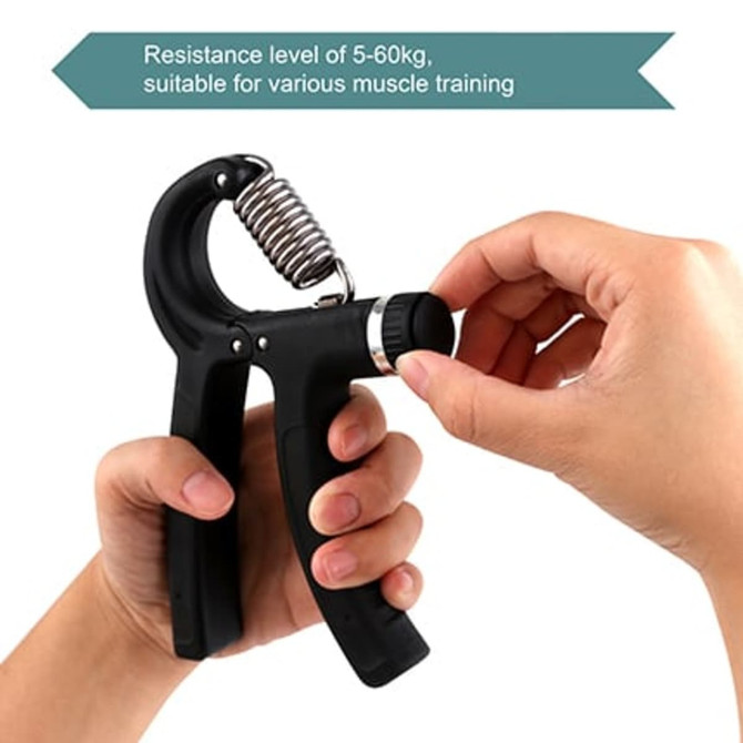 A hand holding a black adjustable hand grip with a metallic spring, featuring a resistance dial.