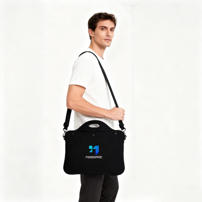 A black laptop bag with a handle, featuring a logo, carried by a person.
