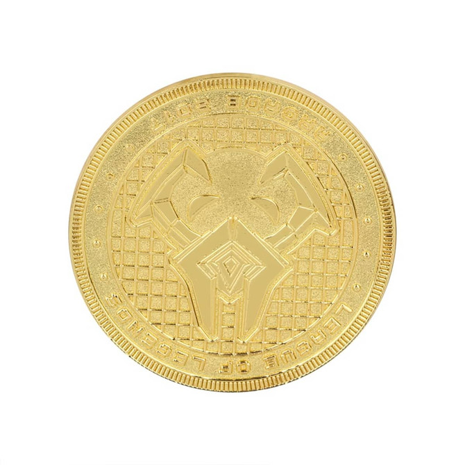 A gold coin pin featuring a textured surface and intricate design. The pin has a logo on it.