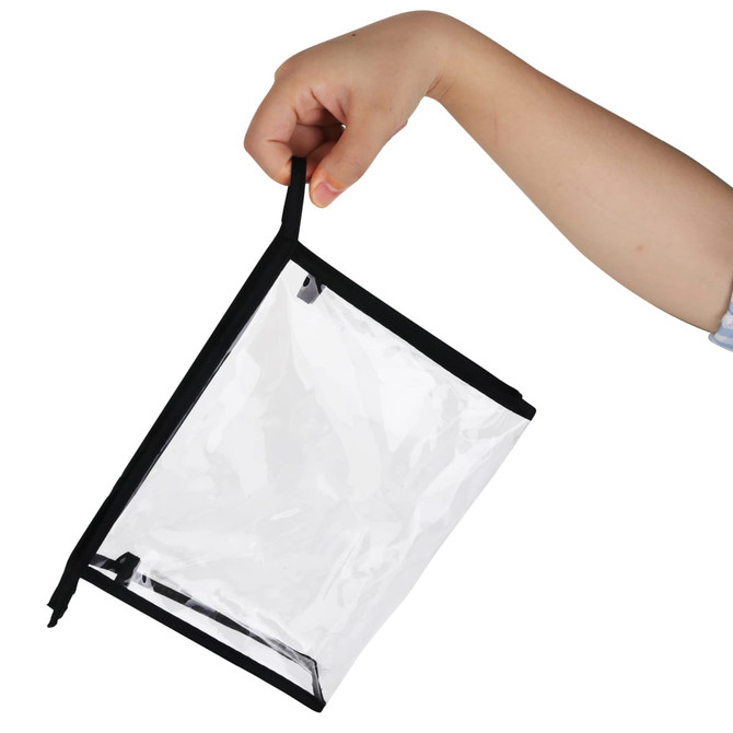 A PVC cosmetic bag with a transparent body and black trim, being held by a hand.
