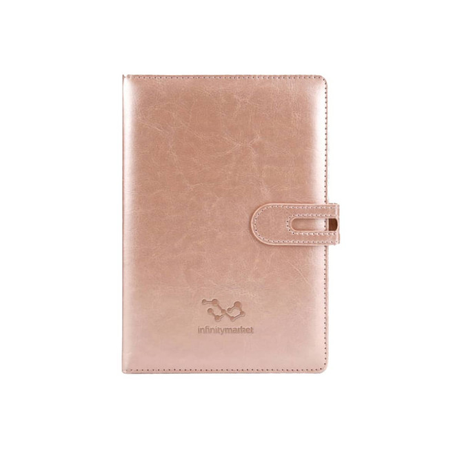 A rose gold notebook with a clasp, featuring a logo on the front cover. Sized for office use.