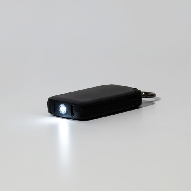 A black mini power bank with a built-in flashlight and keychain attachment.