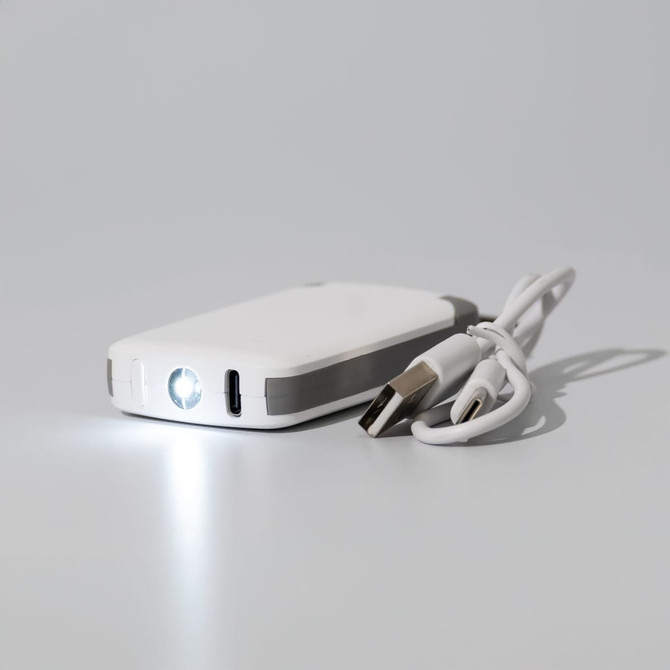 A white mini power bank with a grey accent, featuring a small flashlight and a charging cable.