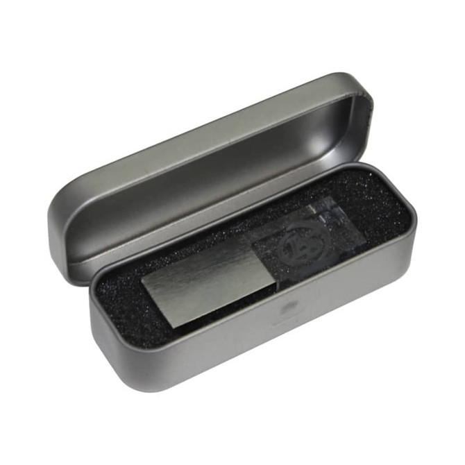 A 3D crystal flash drive in a grey metal case, resting on black foam padding. The case is open.