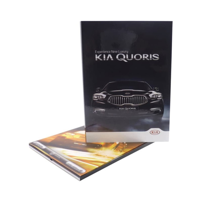 A sleek black brochure featuring a car with a glossy finish. It has a logo and an image of a luxury vehicle on the cover.
