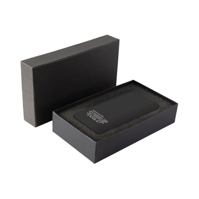 A black wireless power bank with a sleek design, presented in a matching black box with a cushioned interior.