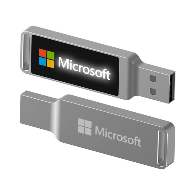 A silver LED flash drive with a logo, featuring a USB connector on one end and a smooth finish.