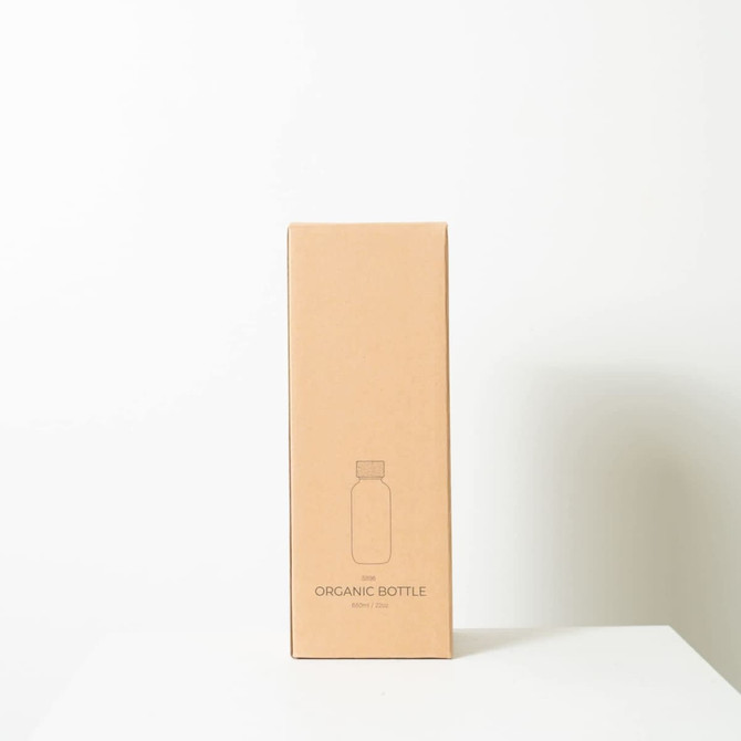 A drink bottle in a simple brown box, featuring a minimalistic design with a logo. The bottle is 650ml.