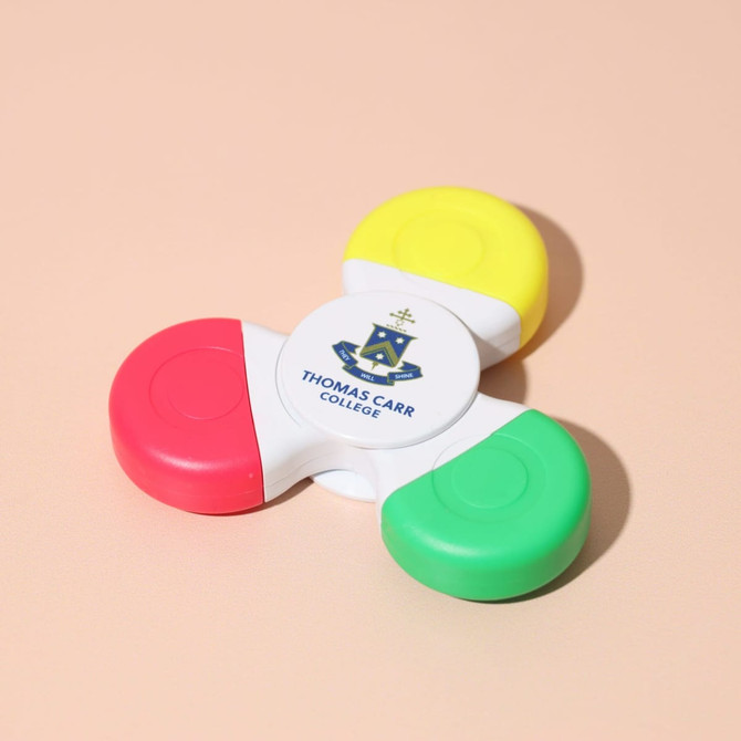 A Fiddle Spinner Highlighter featuring yellow, red, green, and a central white section with a logo. A Fiddle Spinner Highlighter featuring yellow, red, green, and a central white section with a logo.
