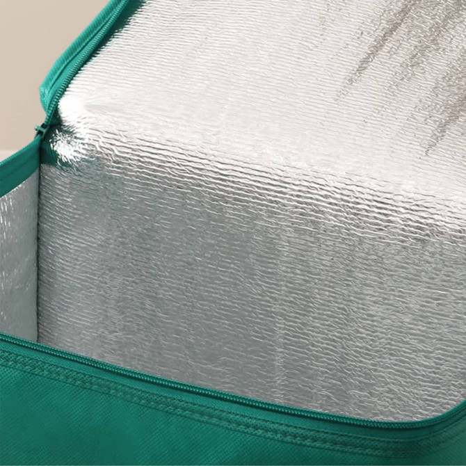 A drink bottle in a green carrier with a reflective silver interior visible inside.